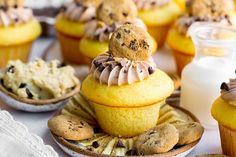 cupcakes and cookies are on plates next to each other