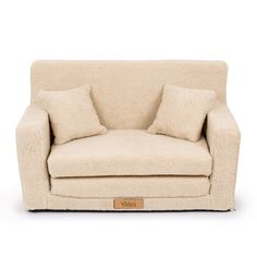 a white couch with two pillows on it's back and the seat upholstered