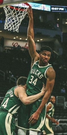 the basketball player is jumping up to dunk the ball