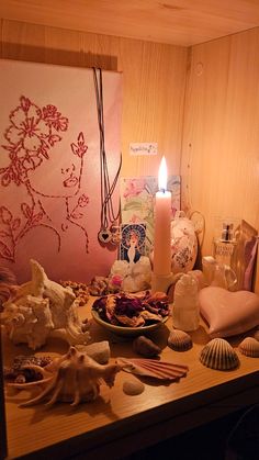 a wooden table topped with shells and candles