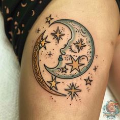 a woman's thigh with a crescent moon and stars on it