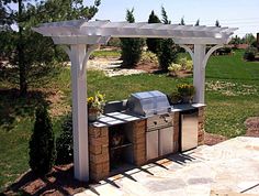 an outdoor bbq with grill and seating area