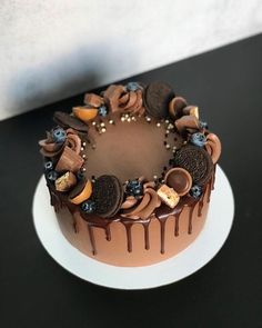 a chocolate cake topped with cookies and oreos