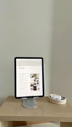 a computer monitor sitting on top of a wooden desk next to a mouse and keyboard