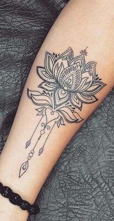 a woman's arm with a tattoo on it and a key in the middle