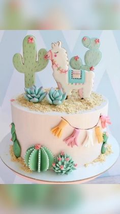 a cake decorated with cactus, cacti and llamas on top of it