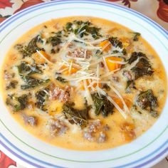 a bowl of soup with meat, cheese and spinach on the top is ready to be eaten