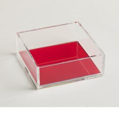 a red and clear box sitting on top of a white table