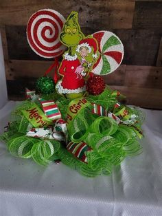 a christmas wreath with candy canes, candies and a dr seuss hat