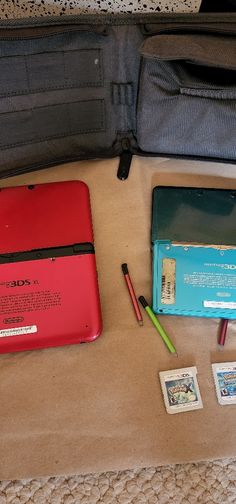 a red and blue laptop sitting on top of a table next to other items in a bag