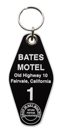 a black and white keychain with an information tag on it that says bats motel old highway 10, fairdale, california