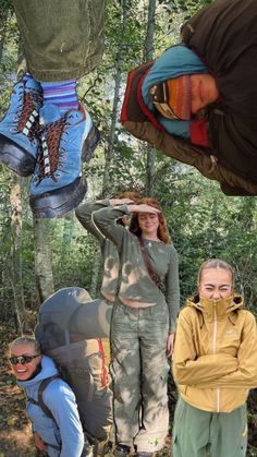 a group of people standing around each other in the woods with shoes hanging from their feet