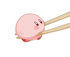 two chopsticks sticking out of the top of a pink object with one eye open