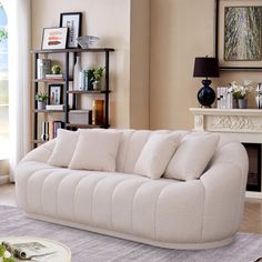 a living room filled with furniture and a fire place in front of a large window