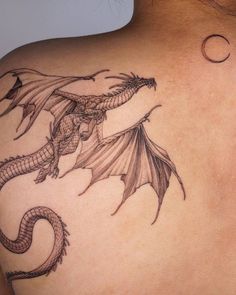 a woman with a dragon tattoo on her back