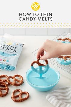 a person is making candy melts with pretzels on the table and in front of them