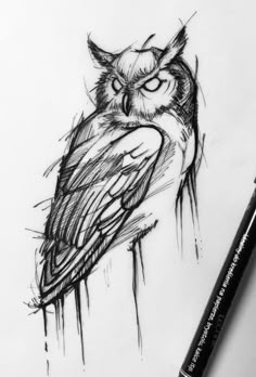 an owl is sitting on top of a piece of paper next to a marker pen