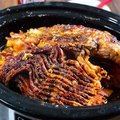 a slow cooker filled with meat and vegetables