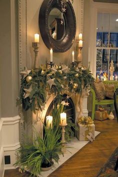 a fireplace decorated for christmas with candles and greenery