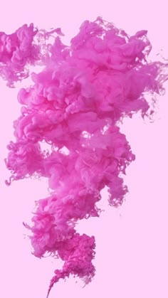 pink ink floating in the air on a light pink background with no one around it