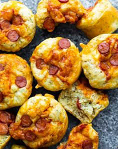 mini pizzas with cheese and pepperoni on top are arranged in a circle, ready to be eaten