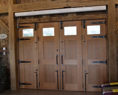 the inside of a horse barn with wooden doors