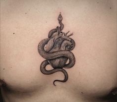 a woman's chest with a snake tattoo on it