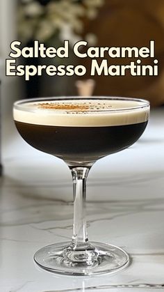 a close up of a drink in a glass on a table with the words salted caramel espresso martini