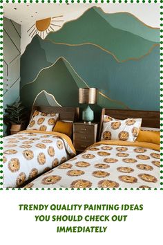 there are two beds in the room with green and yellow decor on them, one has a mountain mural behind it