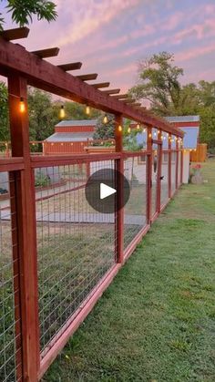 a fence that has lights on it and some grass in front of it with the words,