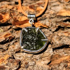 One of a kind! Custom shaped Moldavite and Sterling Silver pendant hand crafted high in the mountains of Northern New Mexico by local silversmith and lapidary artist Michael Silberhorn. Moldavite set in a custom made Sterling Silver setting. I hand form, hand texture and silversmith all the materials for a truly unique piece of art! This item is one of a kind - you will receive the exact item pictured. Approx. 22 mm x 22 mm Approx. 7 grams 8 oz. Shipping Weight * Necklace not included * Handmade Sterling Silver Amulet Jewelry, Artisan Silver Pendant Gemstones, Mogindavid Sterling Silver Jeavy Duty Pendant, Mogindsvid Sterling Silver Pendant, Sterling Silver Etched Amulet Necklace, Moldavite Pendant, Pendant Jewelry, Sterling Silver Pendants, Silver Pendant