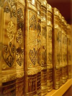 rows of golden books lined up on a shelf