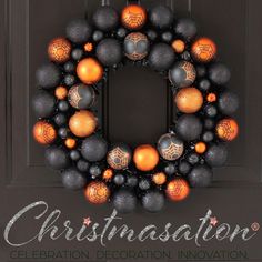 an orange and black christmas ornament wreath on a door with the words christmas station