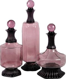 three pink glass vases sitting next to each other