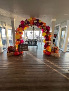 an entrance decorated with balloons and pumpkins for a fall wedding at the beach house