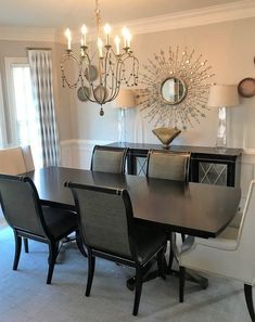 a dining room table with chairs and a chandelier