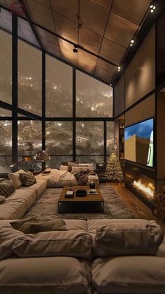 a large living room with couches and a flat screen tv on the wall above it