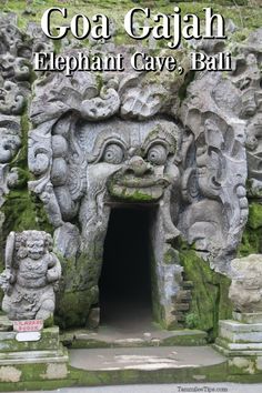 the entrance to an ancient cave with carvings on it's sides and text that reads goa cajah elephant cave, bali