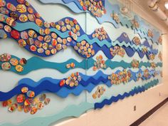 the wall is decorated with colorful fish and waves