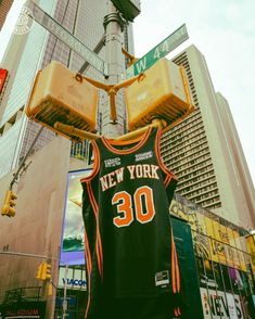 a basketball jersey hanging from a street light in new york city, with the number 30 on it