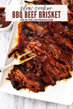 slow cooker bbq beef brisket on a white platter with barbecue sauce