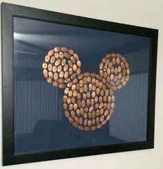 a mickey mouse made out of wine corks hanging on the side of a wall