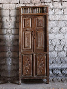 an old wooden door sitting next to a brick wall