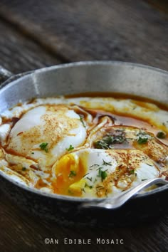 a pan filled with food on top of a wooden table