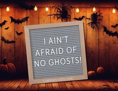 a sign that says i can't afraid of no ghostes in front of some pumpkins