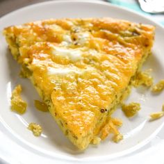 a slice of quiche on a white plate