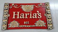 a red sign that says haria's on it with gold trimmings