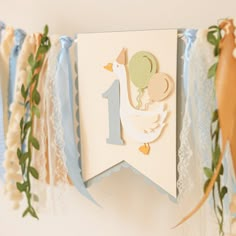 a baby's first birthday banner hanging from a wall