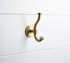 a white dresser with brass handles and knobs