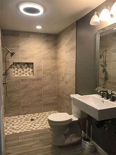 a bathroom with a toilet, sink and shower